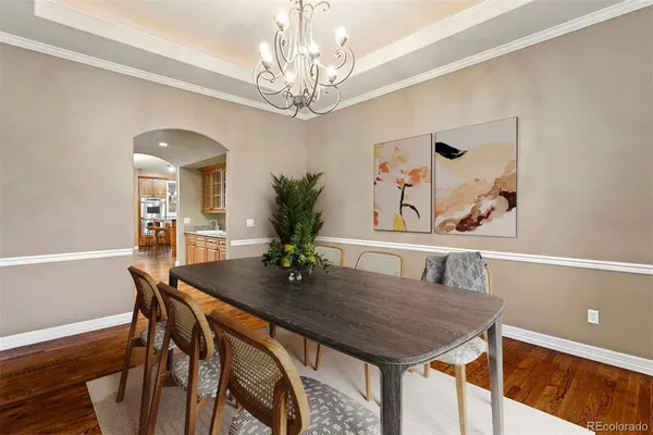 a dining room with furniture and chandelier
