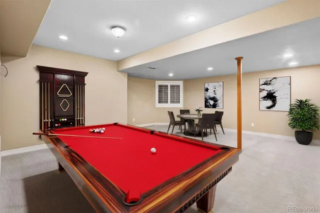 a room with pool table and windows