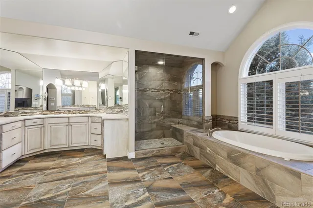 a large bathroom with a large tub and sink