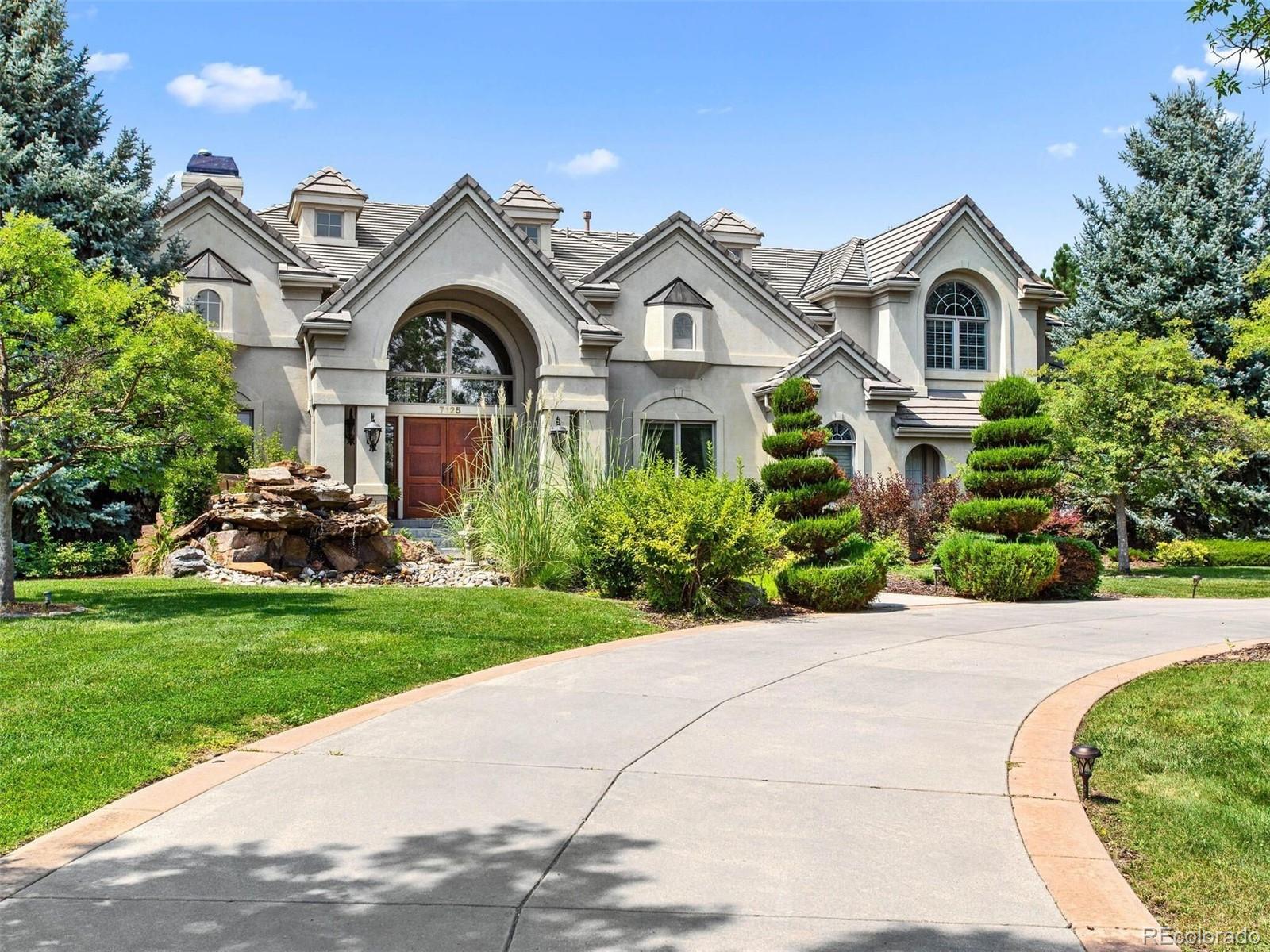 7125 Polo Ridge Drive Littleton, CO 80128 - Photo 23 of 25 a front view of a house with a garden
