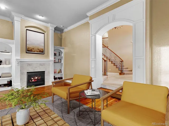 a living room with furniture a fireplace and a table