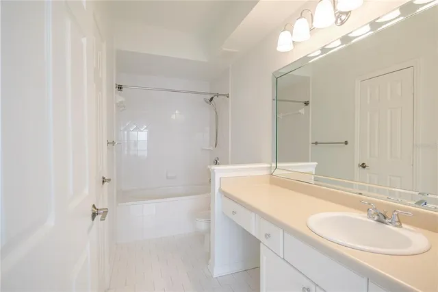 a bathroom with a sink shower and a mirror
