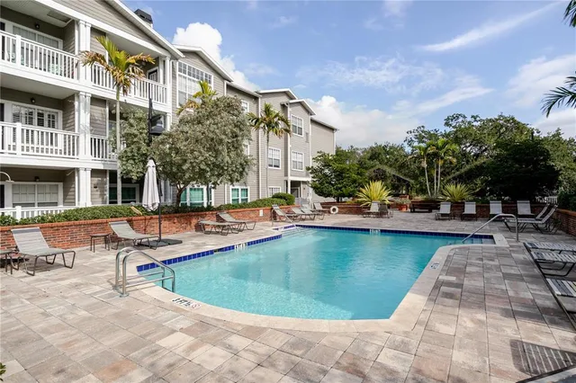 a view of a swimming pool with sitting area