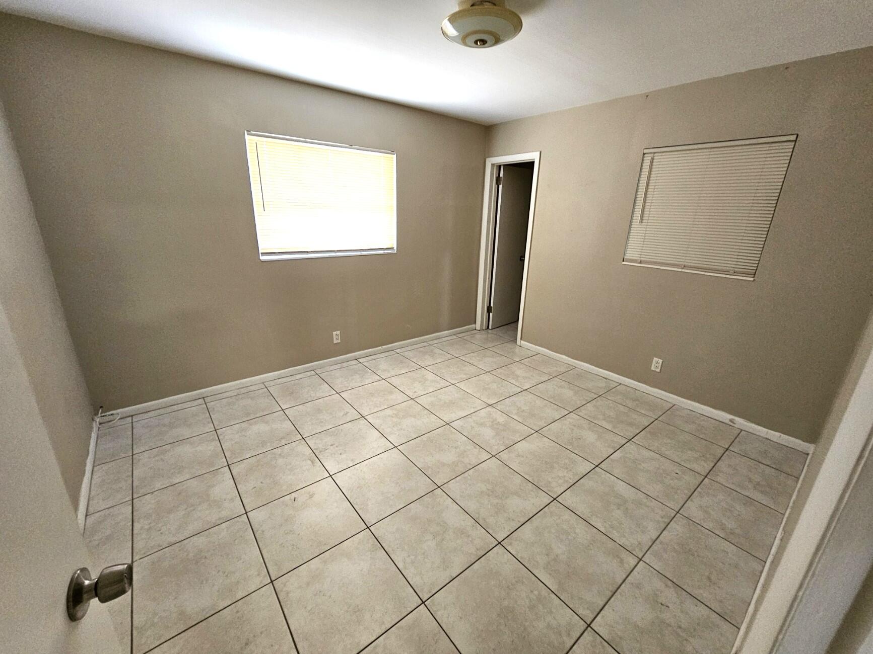 722 Ridge Road, Unit 10 Lantana, FL 33462 - Photo 8 of 13 a view of an empty room and window