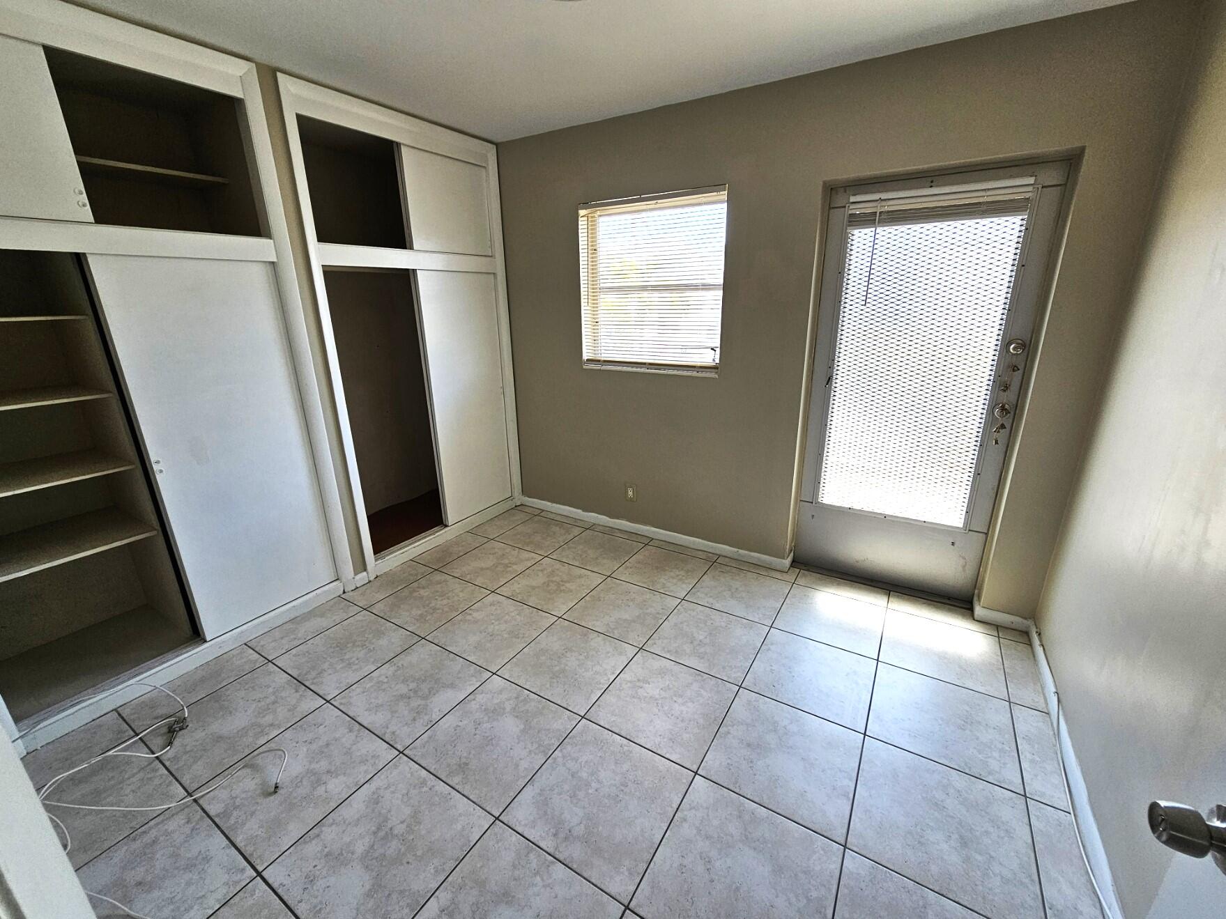722 Ridge Road, Unit 10 Lantana, FL 33462 - Photo 10 of 13 a view of an empty room with windows