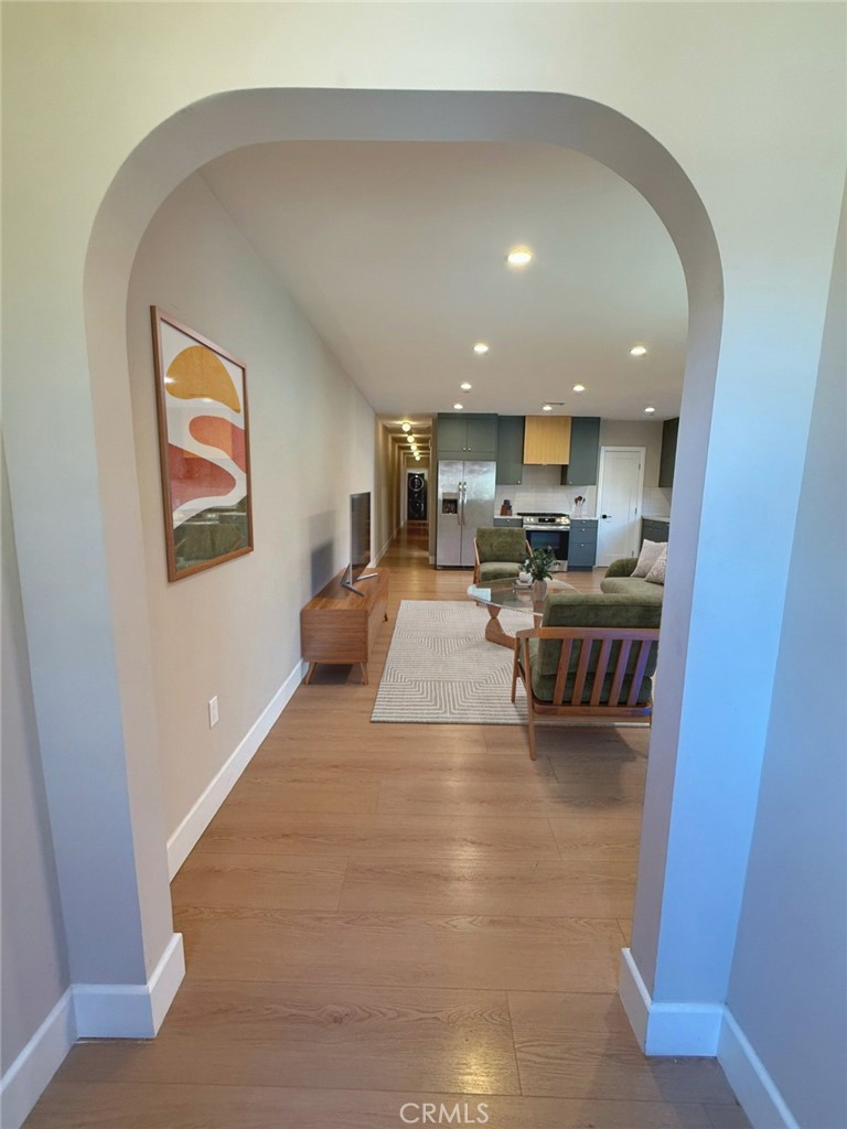 a living room with furniture and a kitchen view