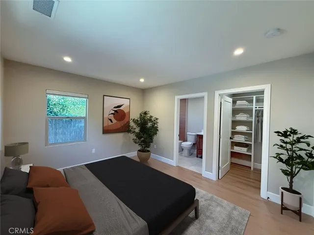 a bedroom with a bed and a couch
