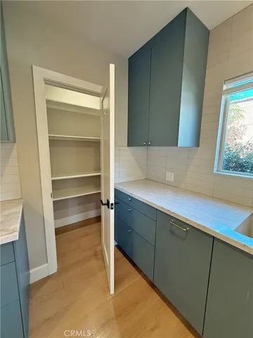 a living room with a wooden floor and a window