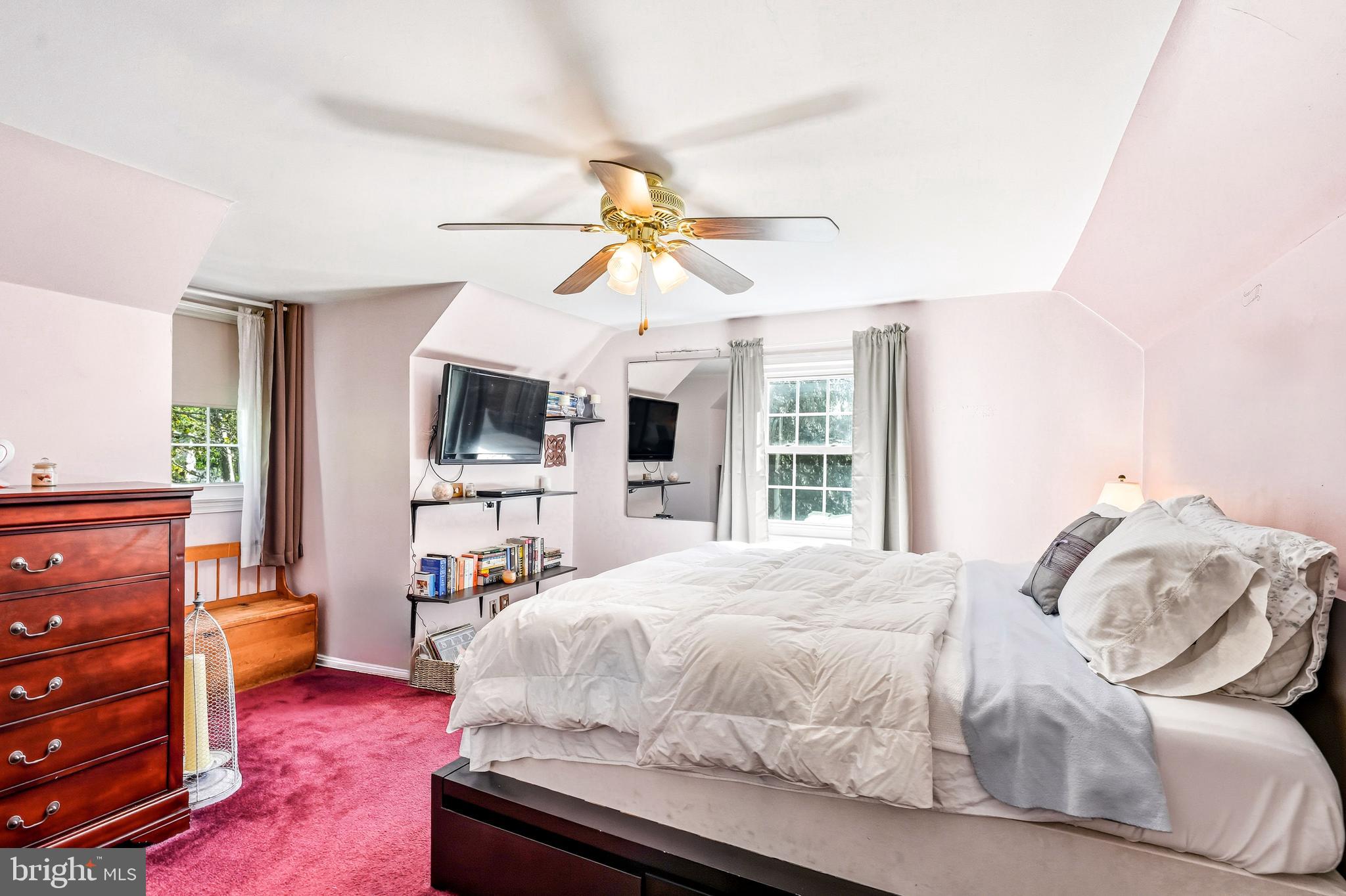 400 Witley Road Wynnewood, PA 19096 - Photo 23 of 38 a bedroom with a bed and a chandelier