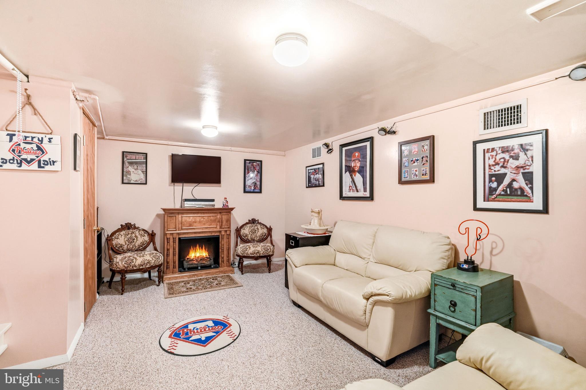 400 Witley Road Wynnewood, PA 19096 - Photo 24 of 38 a living room with furniture a flat screen tv and a fireplace