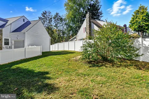 an aerial view of a house with a garden and swimming pool