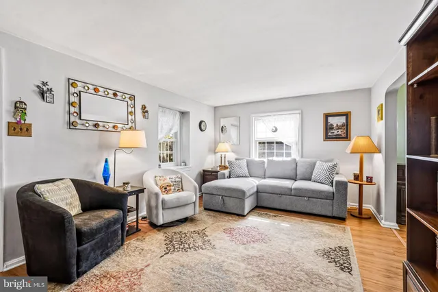 a living room with furniture and a book shelf