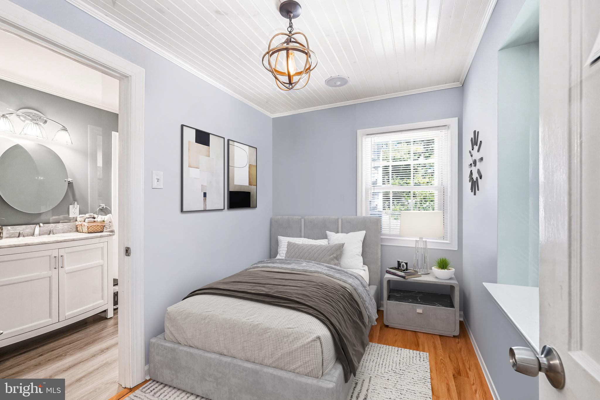 400 Witley Road Wynnewood, PA 19096 - Photo 9 of 38 a bedroom with a bed and a chandelier