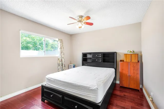 a bedroom with a bed a desk and chair