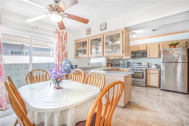 a kitchen with stainless steel appliances granite countertop a sink and a refrigerator