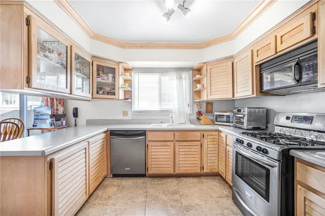 a kitchen with stainless steel appliances granite countertop a stove sink and cabinets