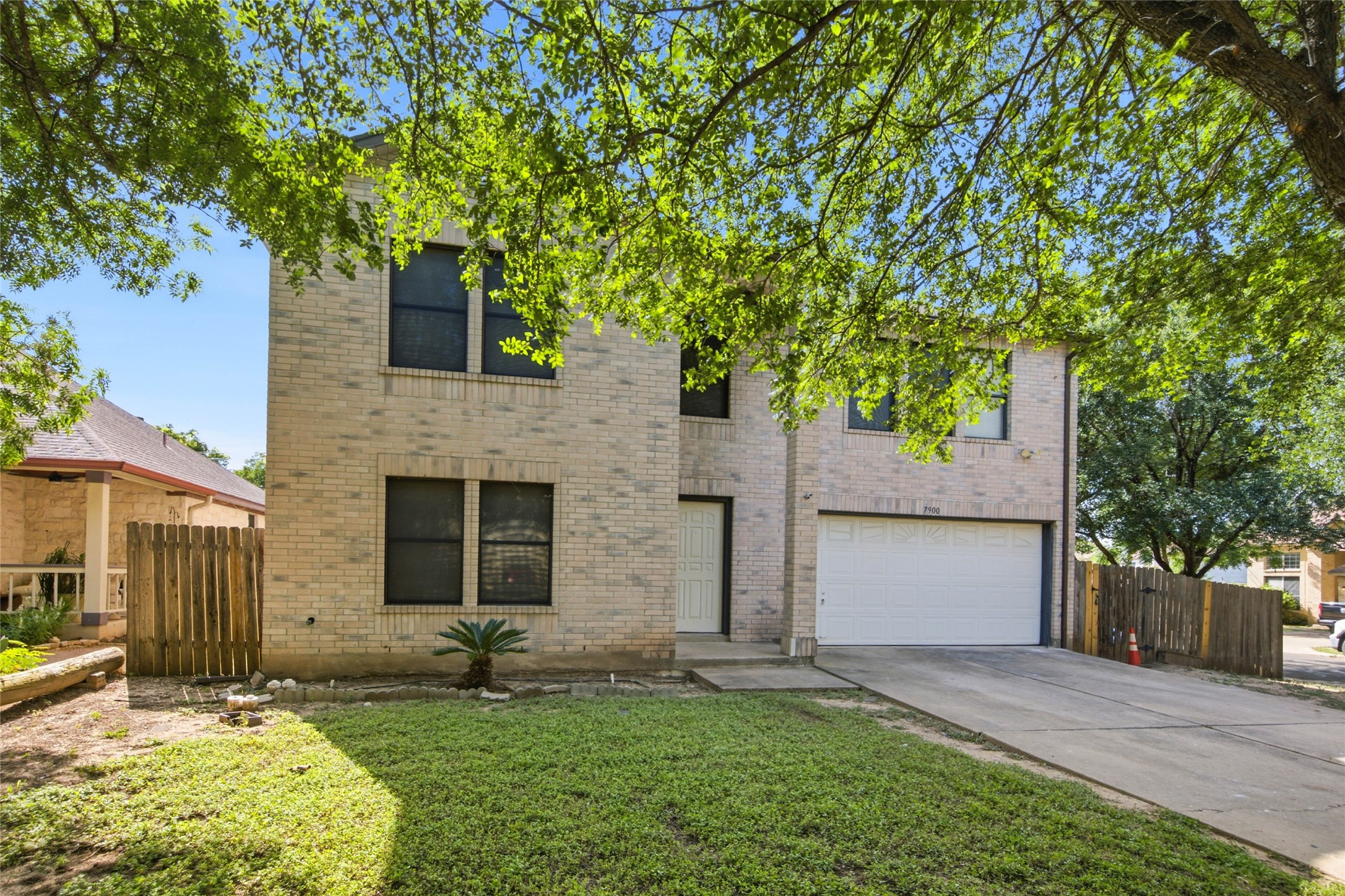 7900 Rosenberry Drive Austin, TX 78747 - Photo 2 of 27 A classic brick exterior offers enduring appeal, complemented by an attached garage and a neatly maintained front yard.
