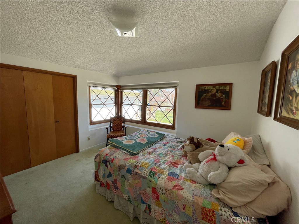 24935 Green Avenue Newhall, CA 91321 - Photo 7 of 11 a bedroom with a bed and a window