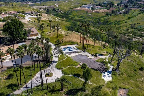 an aerial view of residential house with outdoor space and trees