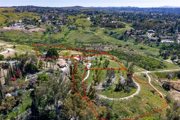 a view of a houses with a lush green hillside