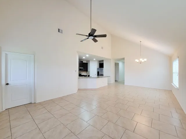a view of a kitchen with a sink and a chandelier fan