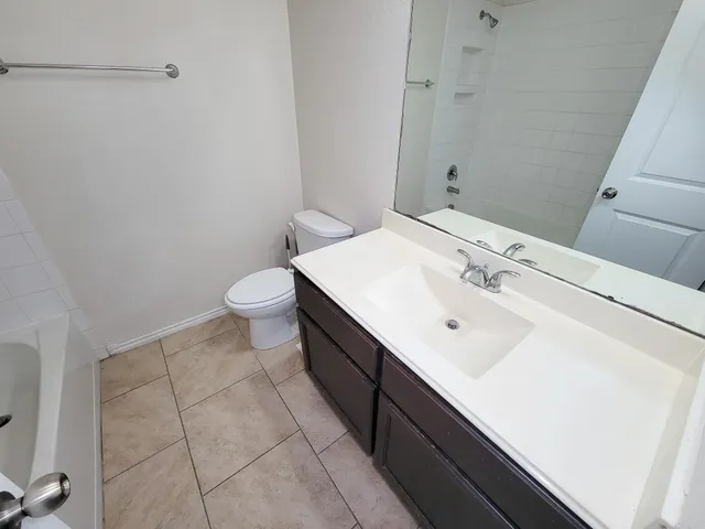 a bathroom with a sink a toilet and vanity