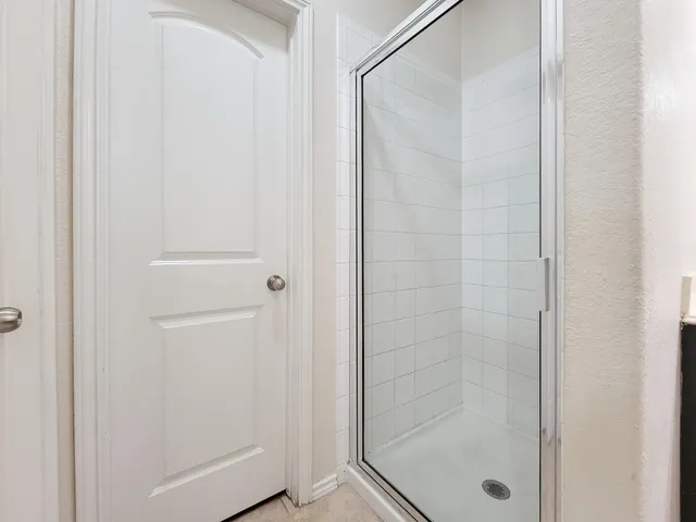 a bathroom with a glass shower door