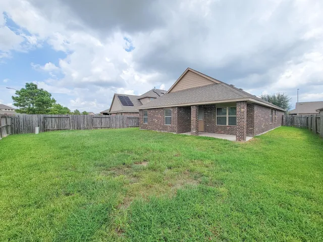 a backyard of a house with lots of green space