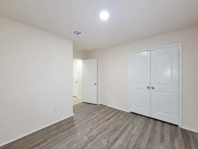 a view of an empty room and wooden floor