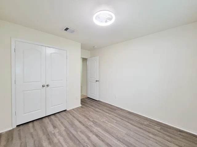a view of an empty room and wooden floor