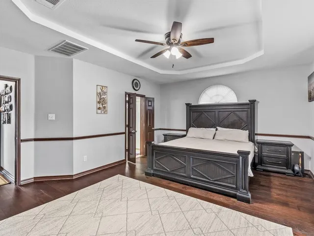 a bedroom with a bed and a chandelier