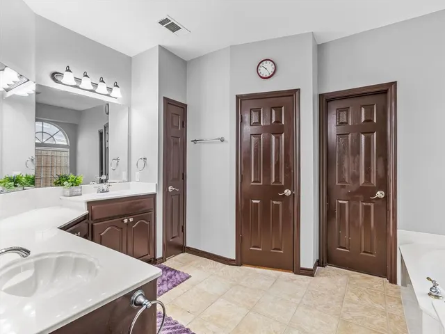 a spacious bathroom with a sink and a mirror