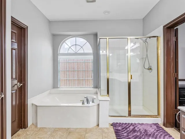 a spacious bathroom with a bathtub and a shower