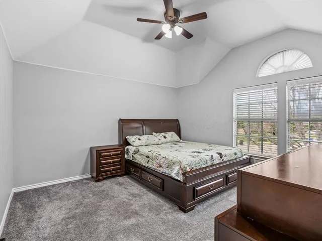 a spacious bedroom with a bed and large windows