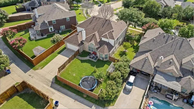 an aerial view of a house with a garden and swimming pool
