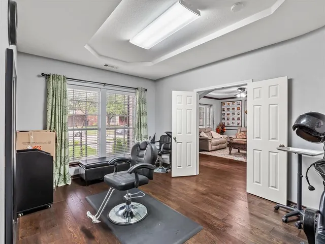 a living room with furniture floor to ceiling window and a flat screen tv