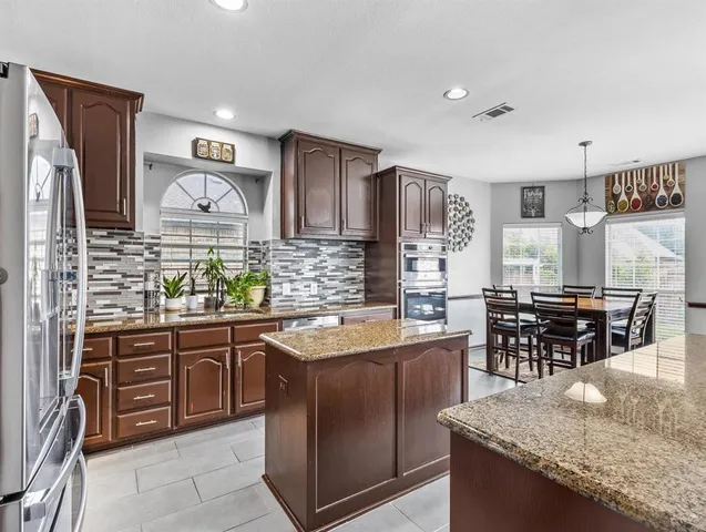 a kitchen with stainless steel appliances granite countertop a sink and cabinets