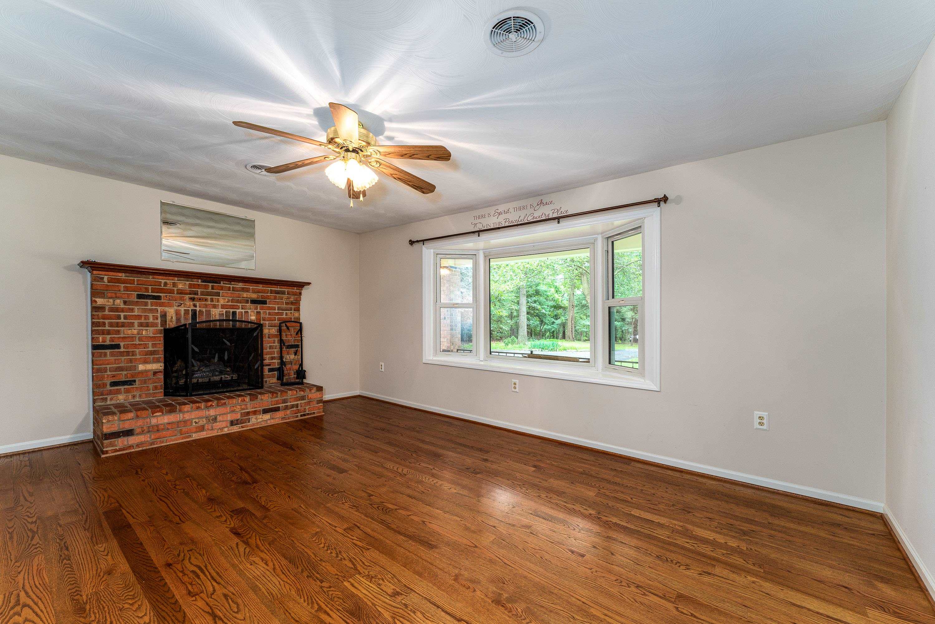 431 Springfield Estates Drive Rileyville, VA 22650 - Photo 12 of 44 an empty room with windows and a fireplace