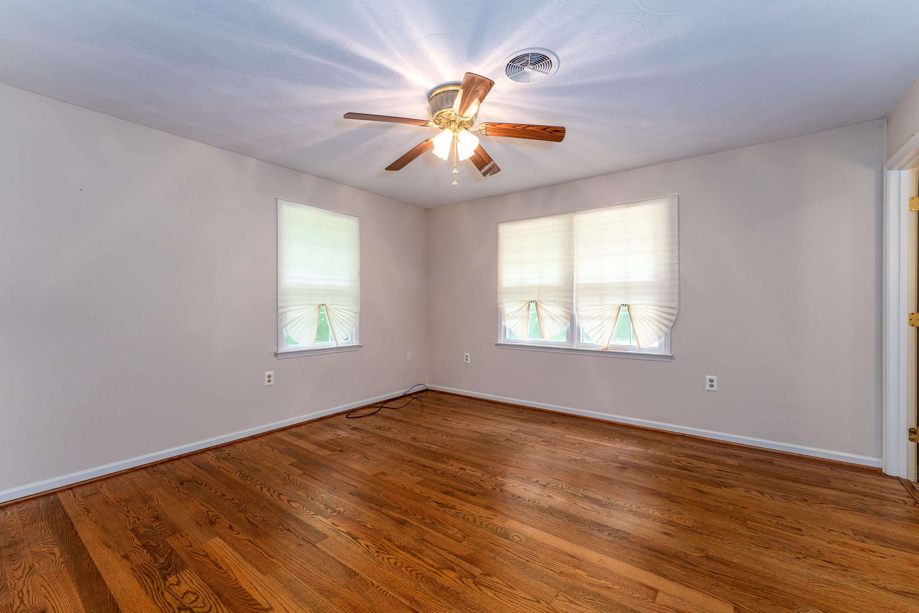 431 Springfield Estates Drive Rileyville, VA 22650 - Photo 14 of 44 wooden floor in an empty room with a window