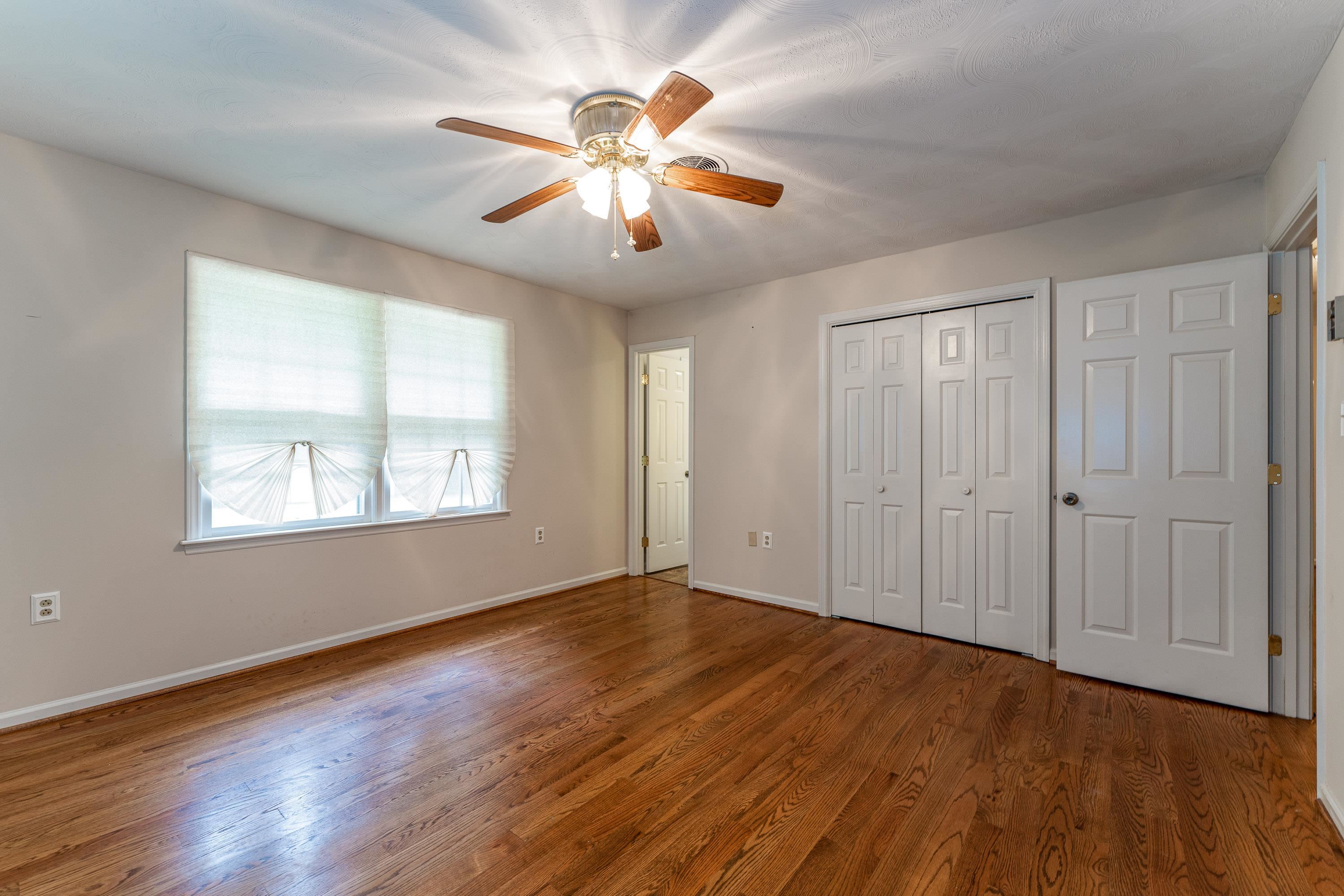 431 Springfield Estates Drive Rileyville, VA 22650 - Photo 15 of 44 a view of an empty room with wooden floor and a window
