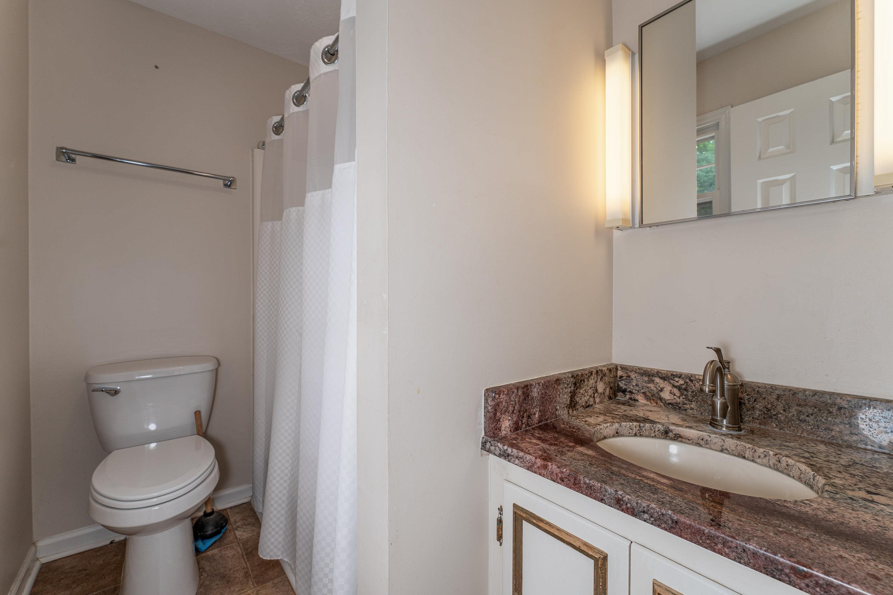 431 Springfield Estates Drive Rileyville, VA 22650 - Photo 16 of 44 a bathroom with a granite countertop toilet sink and mirror