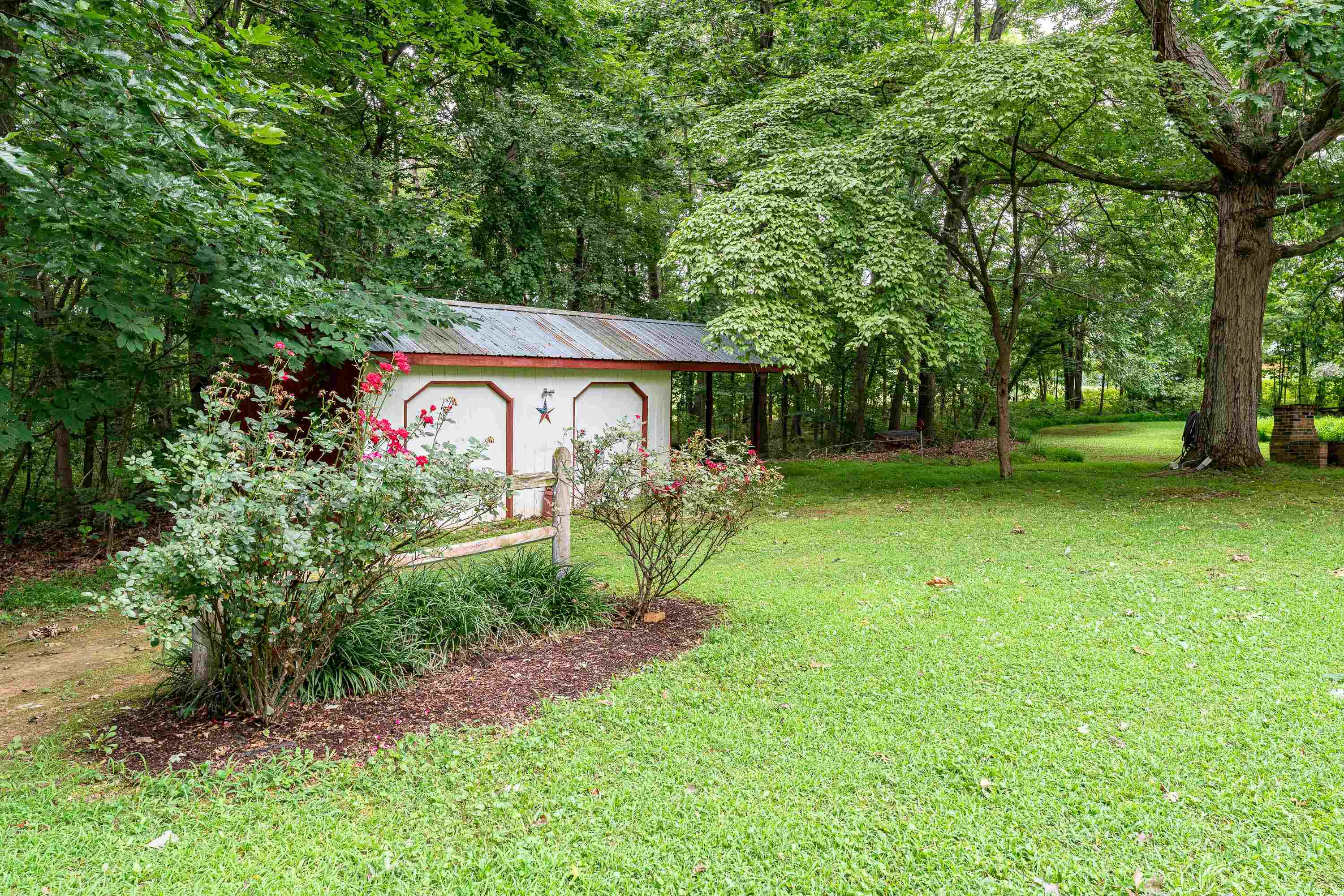 431 Springfield Estates Drive Rileyville, VA 22650 - Photo 32 of 44 a view of a garden with a bench and trees