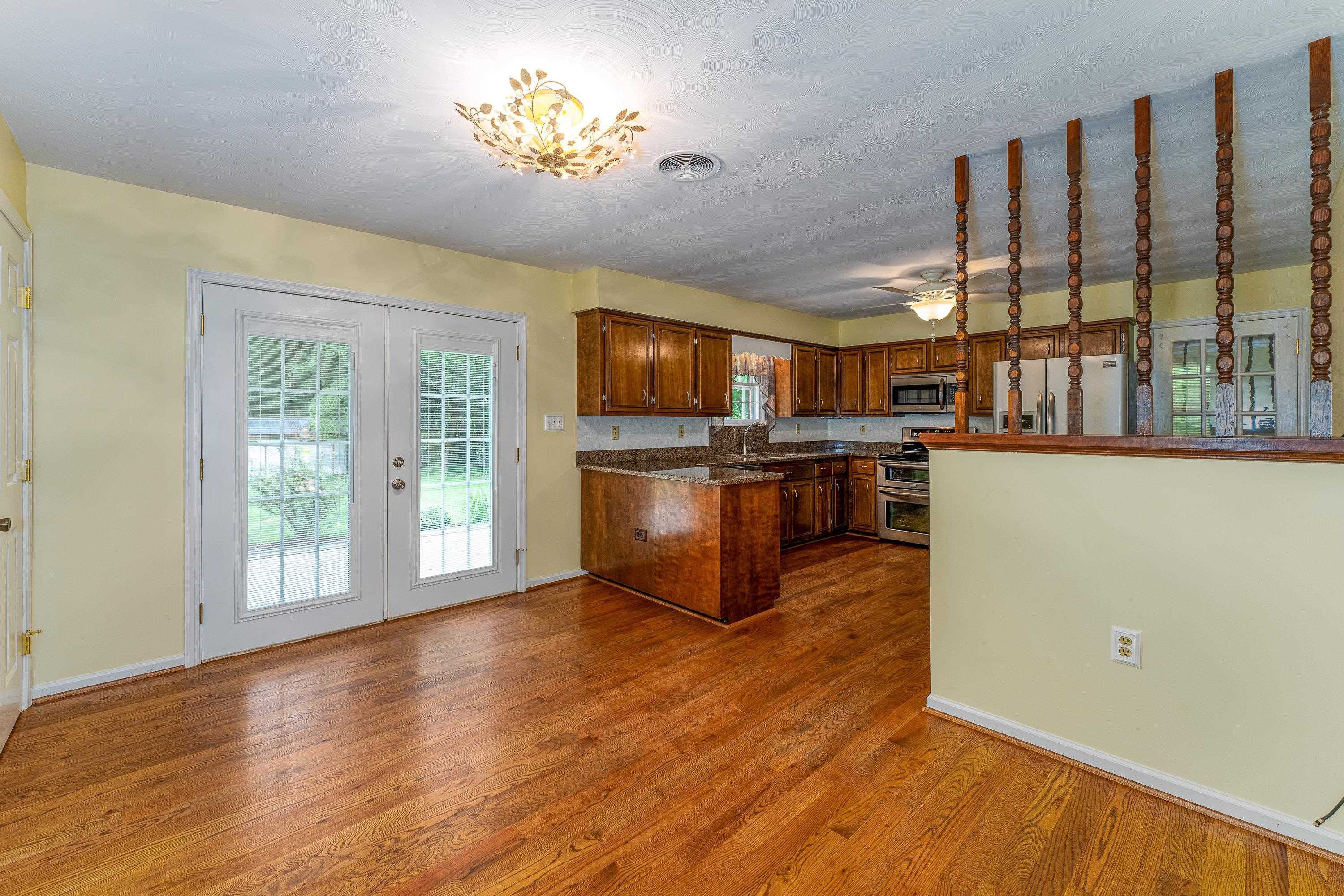 431 Springfield Estates Drive Rileyville, VA 22650 - Photo 5 of 44 a view of a kitchen with stainless steel appliances granite countertop a stove top oven a refrigerator with wooden floor and cabinets