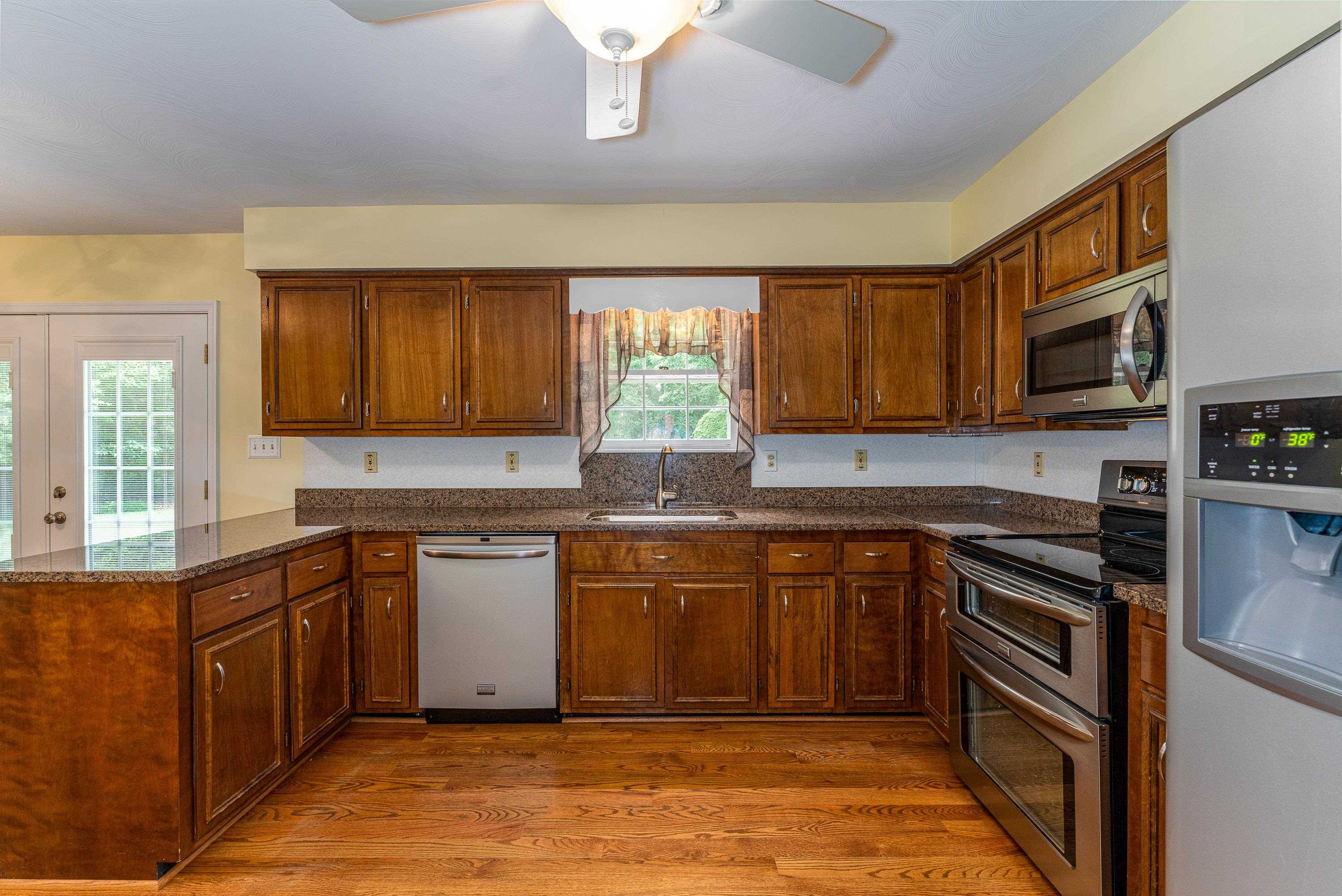 431 Springfield Estates Drive Rileyville, VA 22650 - Photo 7 of 44 a kitchen with stainless steel appliances granite countertop wooden cabinets a stove top oven a sink and dishwasher