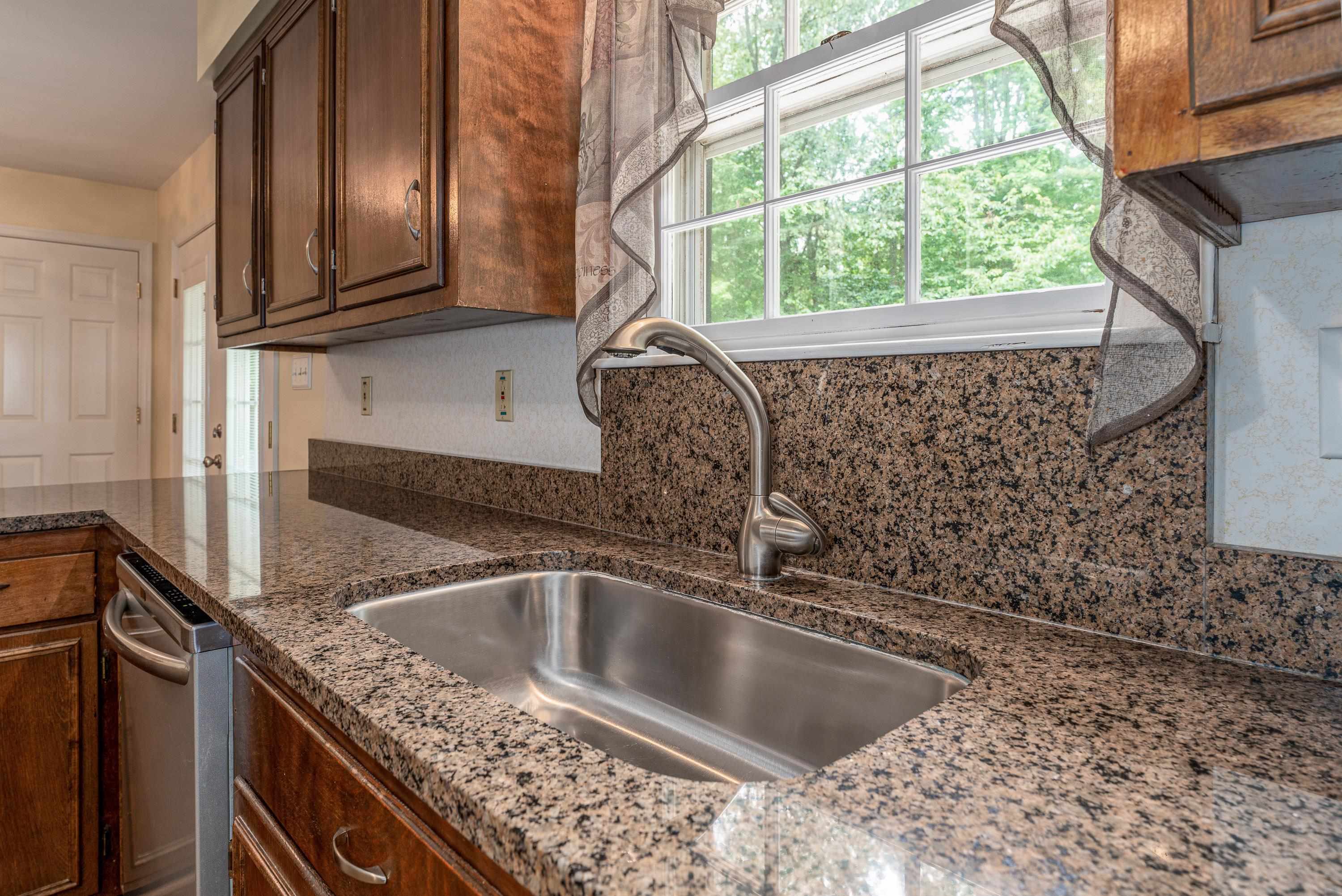 431 Springfield Estates Drive Rileyville, VA 22650 - Photo 10 of 44 a kitchen with a sink a counter top and a window