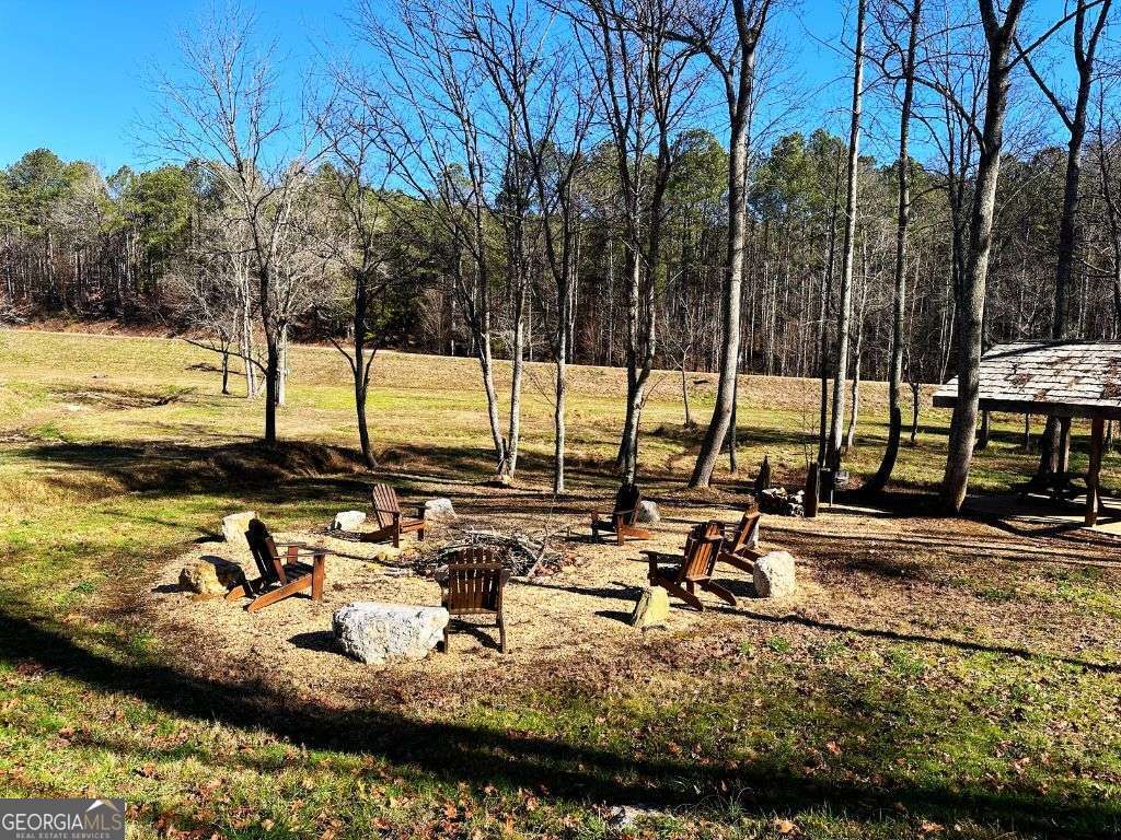 Lot 147 Creekside Crossing Talking Rock, GA 30175 - Photo 45 of 49 a view of a lake with chairs and trees