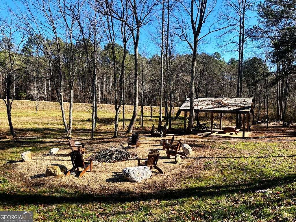 Lot 147 Creekside Crossing Talking Rock, GA 30175 - Photo 49 of 49 a view of a lake with chairs and trees
