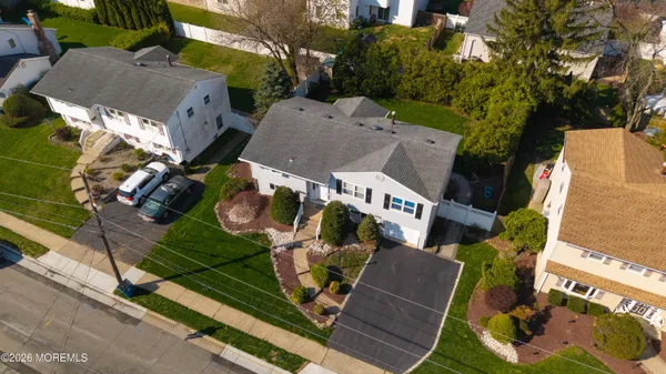 an aerial view of multiple houses with yard