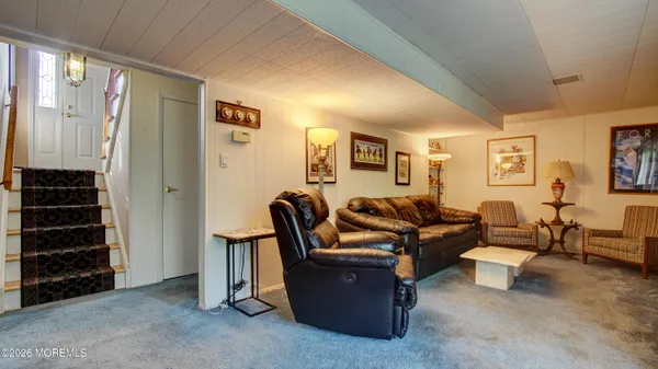 a living room with furniture and a closet