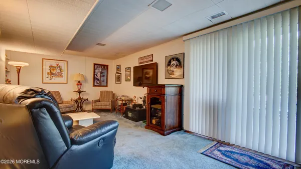 a living room with furniture a couch and a window